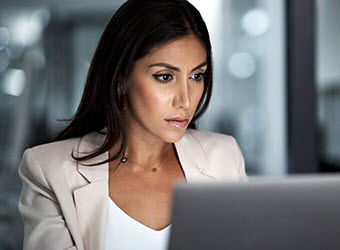 A businesswoman working at a computer